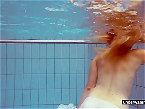 adorable redhead plays bare underwater